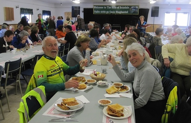 Cyclists Jacques Cote and Micheline Guillot enjoying the Pancake and Maple Syrup Breakfast, May 18 at the Boisdale Firehall - photo: Shelley Johnson