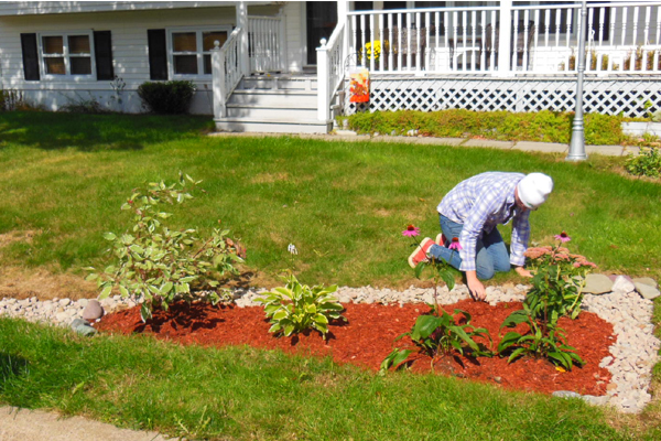 Sarah Penney, ACAP Project Coordinator, installing a rain garden to help a homeowner manage stormwater on her property.
