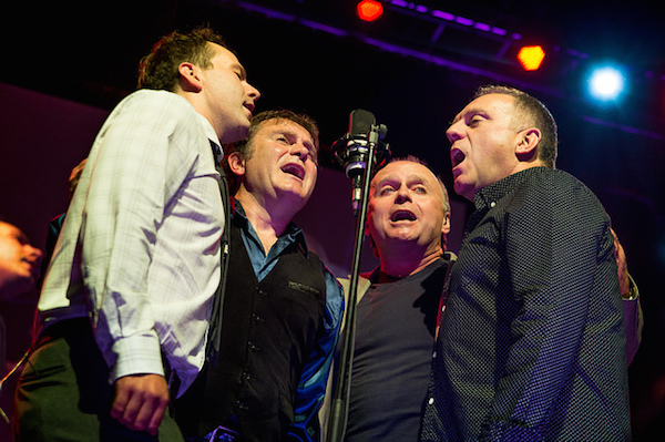 Boyd, Stewart, Kyle and Sheumas of the Barra MacNeils singing Stewart's song "The Underachiever" during the Celtic Colours closing concert Ricky's Rattlin' Roarin' Roots at Centre 200 in Sydney. - photo: Corey Katz