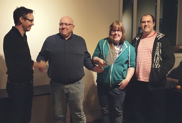 Marcato co-founder and Chief Technical Officer Morgan Currie (left) presents Marcato Hackathon's 1st place honours to the winning team of  Bob White, Ardell MacKinnon, and Corey Musgrave - photo: Alison Giovannetti 